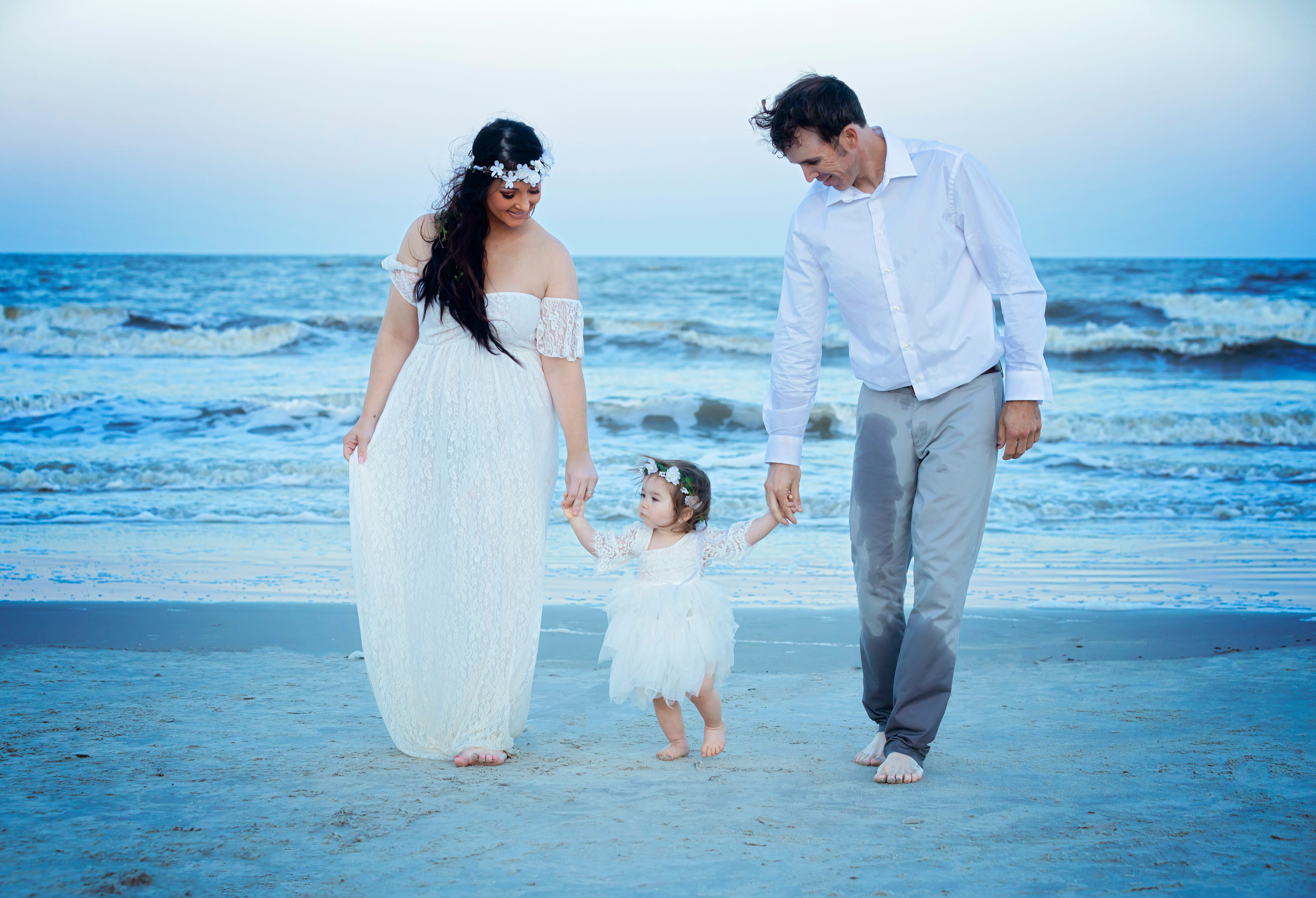 Couple holding hands with their child