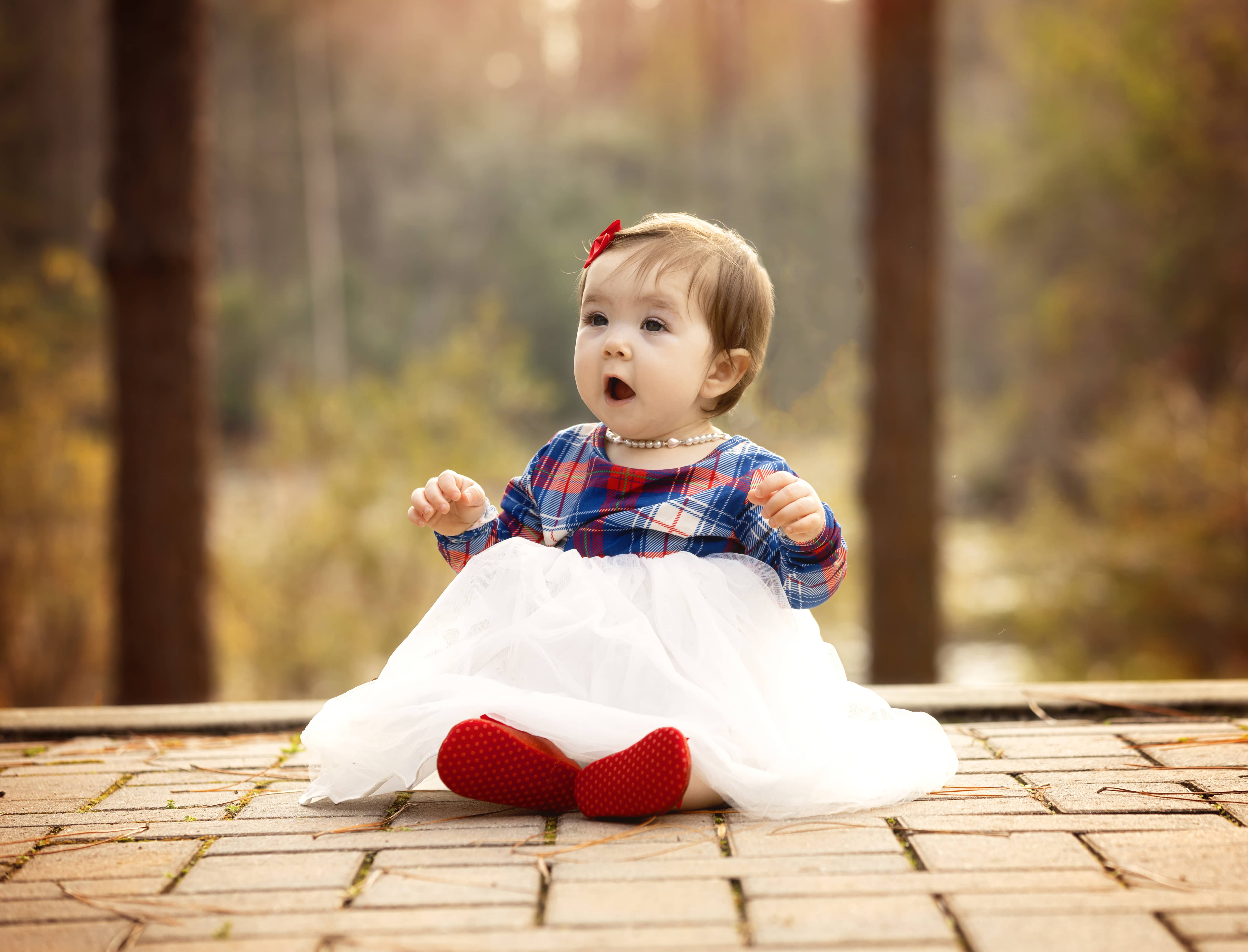 Small child sits on the ground