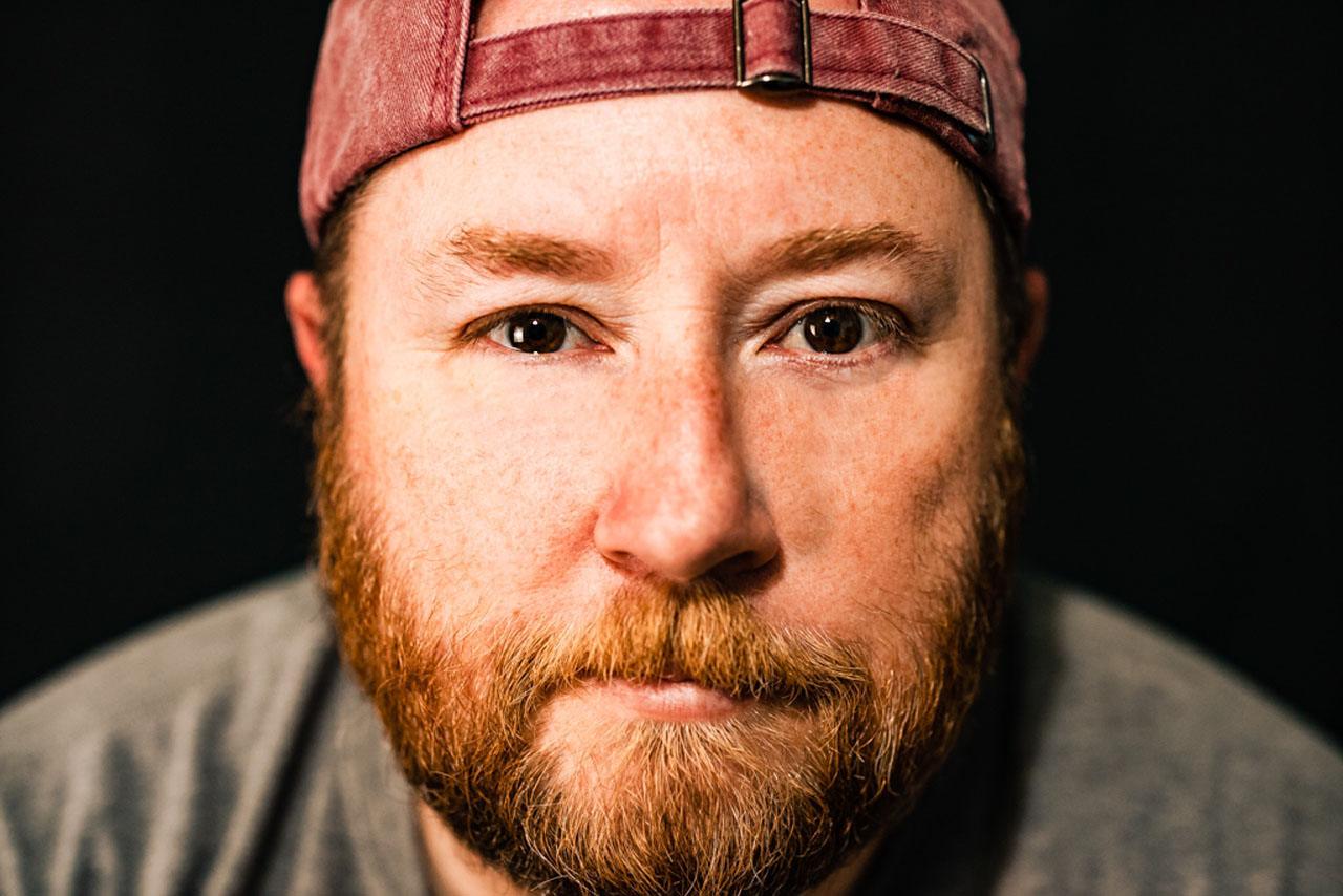 A Man wearing a hat backwards