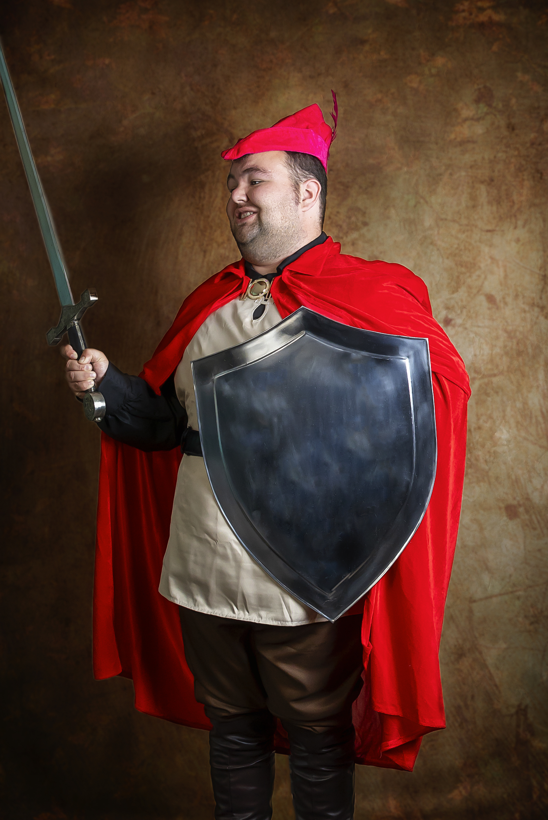 Man holding prop sword and shield